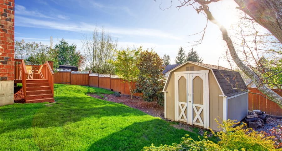 Fenced backyard with storage shed in Waco